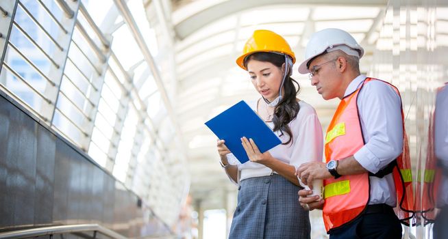 Construction engineers discussion with architects at construction site or building site