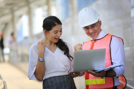 Construction engineers discussion with architects at construction site or building site