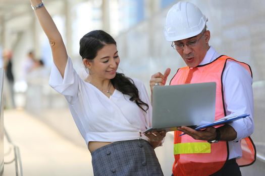 Construction engineers discussion with architects at construction site or building site