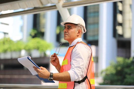 Construction engineers discussion with architects at construction site or building site