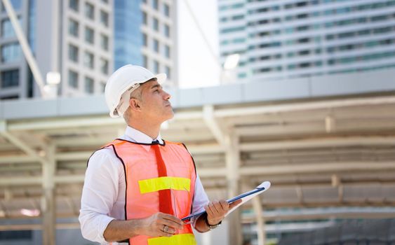 Construction engineers discussion with architects at construction site or building site