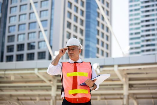 The engineer and business people hand high five against building. The concept of engineering, construction, city life and future.