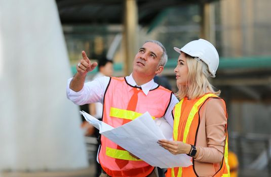 The engineer and business people hand high five against building. The concept of engineering, construction, city life and future.