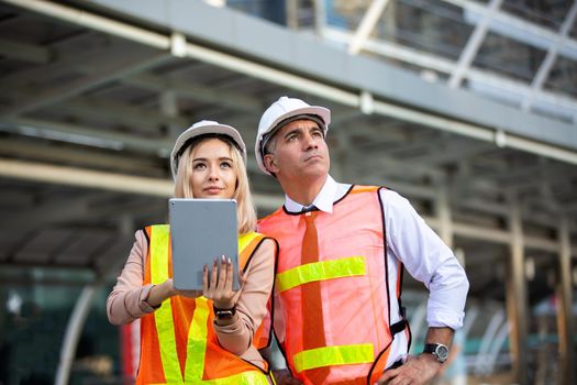 Construction engineers discussion with architects at construction site or building site