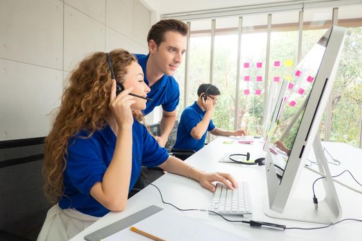 Call center team at the office, side view.the call center operator and her colleagues work in the office.