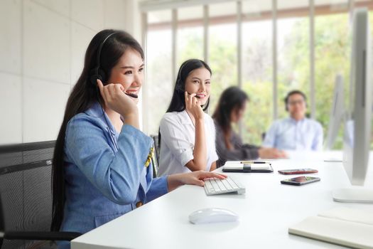 Call center operator in headset while consulting client. Telemarketing or phone sales. Customer service and business concept.