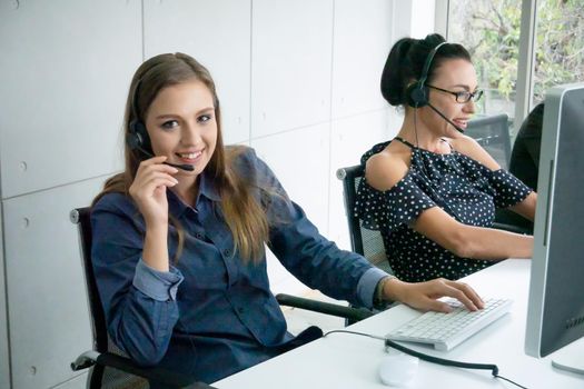 Call center operator in headset while consulting client. Telemarketing or phone sales. Customer service and business concept.