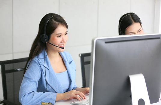 Call center operator in headset while consulting client. Telemarketing or phone sales. Customer service and business concept.