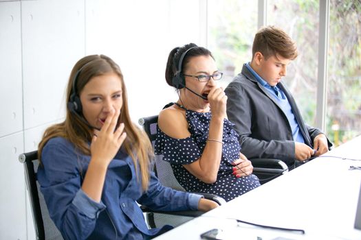 Call center operator in headset while consulting client. Telemarketing or phone sales. Customer service and business concept.