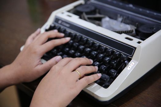 Close-up on women hand typing on type writer.