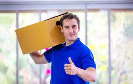 delivery man blue t-shirt holding box in call center office