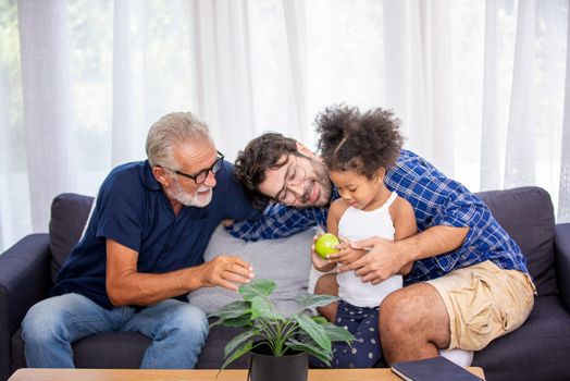 Mix race of family, dad, mom and daughters play together in living room