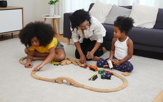 Mix race of family, dad, mom and daughters play together in living room	

