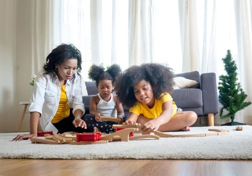 Mix race of family, dad, mom and daughters play together in living room	
