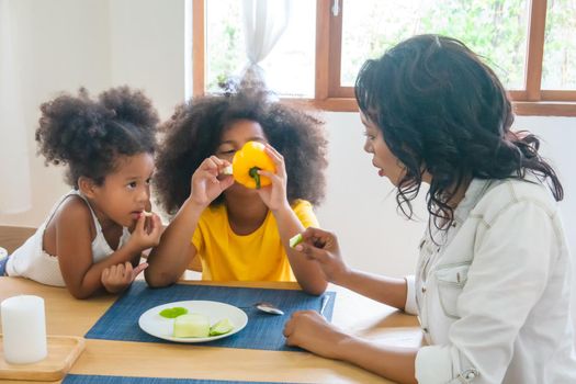 Mix race of family, dad, mom and daughters play together in living room