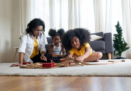 Mix race of family, dad, mom and daughters play together in living room	
