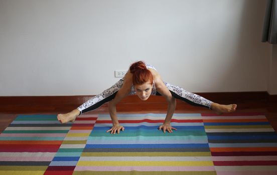Women practice yoga at home