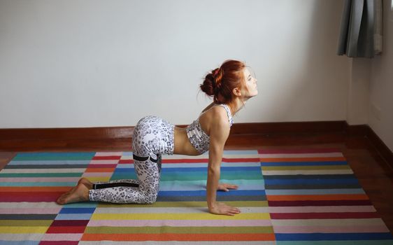 Women practice yoga at home