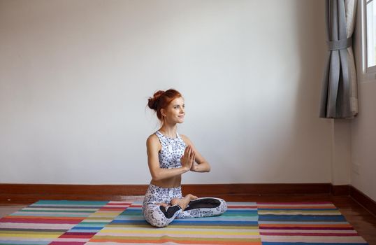 Women practice yoga at home