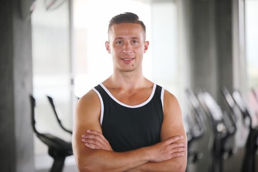 sport, fitness, lifestyle and people concept - group of men flexing muscles with dumbbells in gym