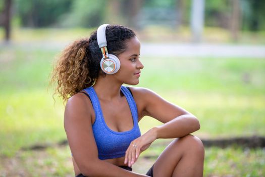 Young attractive smiling woman practicing yoga pose, working out, wearing sportswear pants, bra, full length, outdoor.