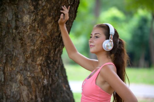 young active women with head phone exercise in park.