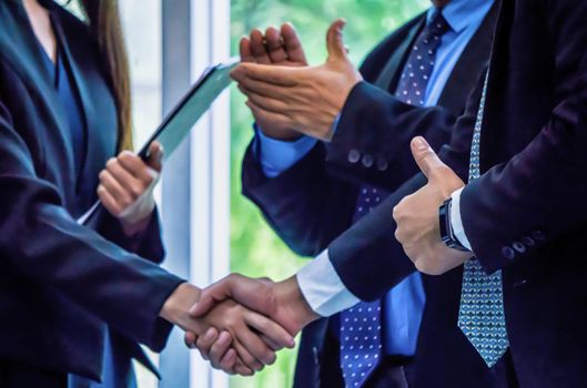 Business people shaking hands, finishing up a papers signing. Meeting, contract and lawyer consulting concept.