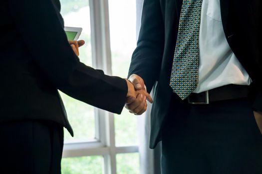 Business people shaking hands, finishing up a papers signing. Meeting, contract and lawyer consulting concept.