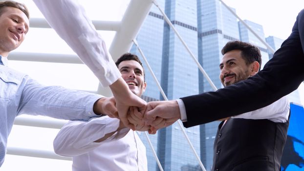 Close up top view of young business people putting their hands together. Stack of hands. Unity and teamwork concept.