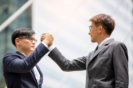 Business people give hands stack or holding each other for Unity and teamwork concept.