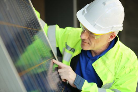 maintenance engineer, Solar energy systems engineer perform analysis solar panels, Portrait of engineer man or worker, people, with solar panels or solar cells on the roof in farm. Power plant with green field, renewable energy source in American. Eco technology for electric power.