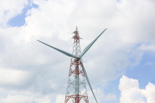 clean energy power concept, wind turbine and cloud sky.