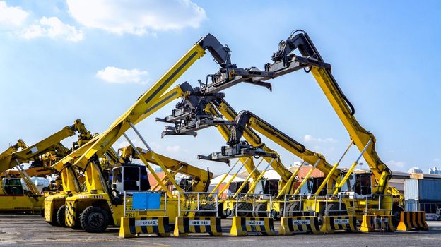 Logistics and transportation of Container Cargo ship and Cargo plane with working crane bridge in shipyard at sunrise, logistic import export and transport industry background