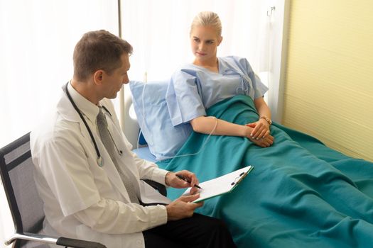 Doctor check up and discuss with patient in clinic or doctor talk with women patient in hospital