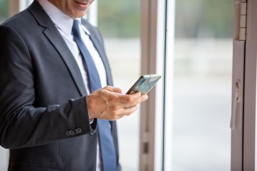 midsection of businessman using smart phone