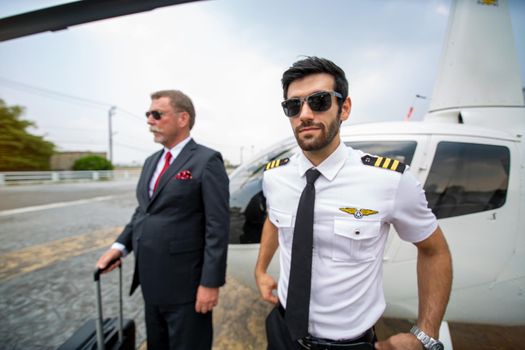 Business people traveling by helicopter , Shot of a mature businessman using a headset while traveling in a helicopter