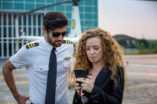 Shot of a mature Helicopter pilot using a headset while traveling in a helicopter, Business people traveling by helicopter