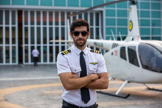 Shot of a mature Helicopter pilot using a headset while traveling in a helicopter, Business people traveling by helicopter