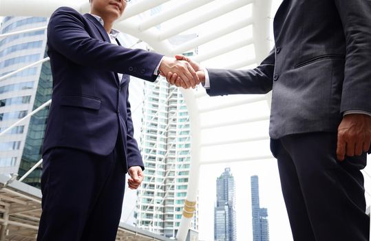 Business people shaking hands, finishing up a papers signing. Meeting, contract and lawyer consulting concept.