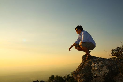 a man on a mountain top. Person on the rock. Sport and active life concept. Beauty world.