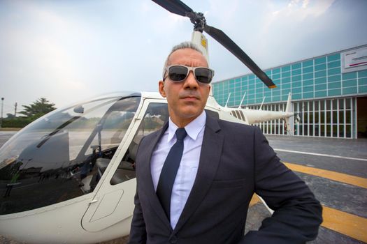 Business people traveling by helicopter , Shot of a mature businessman using a headset while traveling in a helicopter