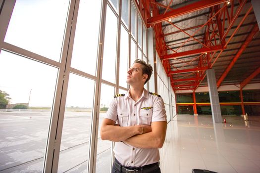 Shot of a mature Helicopter pilot using a headset while traveling in a helicopter, Business people traveling by helicopter