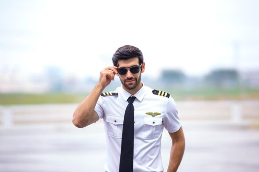 Shot of a mature Helicopter pilot using a headset while traveling in a helicopter, Business people traveling by helicopter