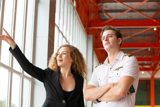 confident business people standing against his private helicopter at landing airport. Professional career success concept	