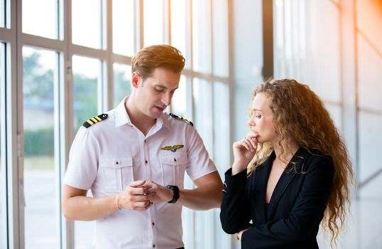 confident business people standing against his private helicopter at landing airport. Professional career success concept	