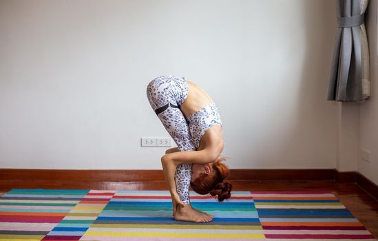 Women practice yoga at home