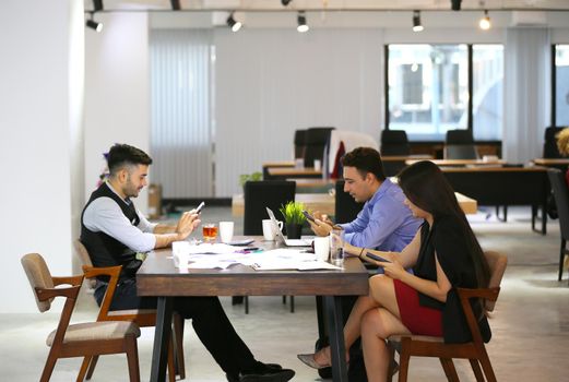 Business people working in office on desktop computer, Group of happy business people in smart casual wear looking at the laptop and gesturing. Achieving success.