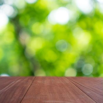 Selective focus of empty old wood on blur nature green leaf with bokeh abstract background.