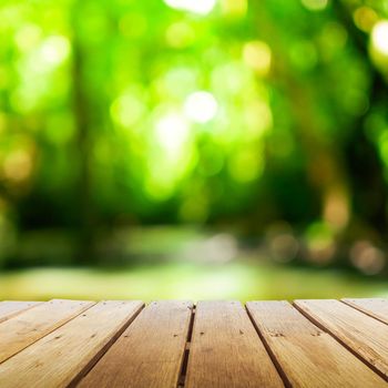 Selective focus of empty old wood on blur nature green leaf with bokeh abstract background.