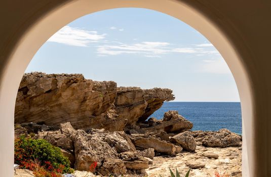 View out of an archway at the rocky coastline at Kallithea Therms, Kallithea Spring on Rhodes island, Greece